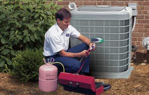 repairman working on outdoor ac unit