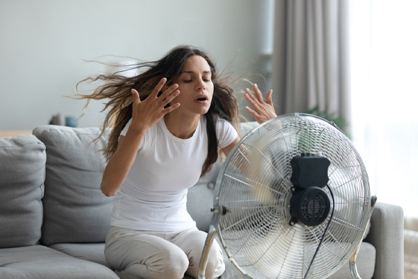image of homeowner suffering from extreme heat indoors