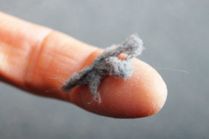 image of dust from furnace on homeowner's finger