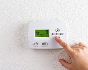 image of New Brunswick NJ homeowner with programmable thermostat