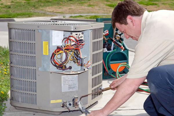 image of an hvac contractor performing an air conditioner installation