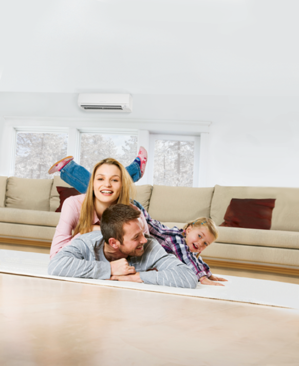 family on the floor with Mitsubishi ductless in background
