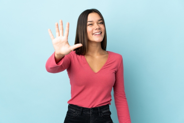 woman holding 5 fingers up depicting Five Reasons to Schedule Annual Furnace Tune-Up
