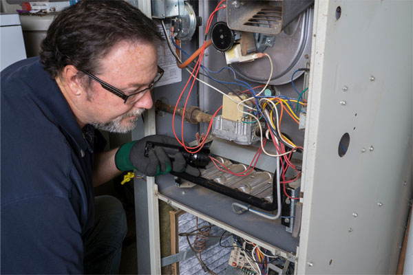 image of an hvac contractor performing a furnace repair