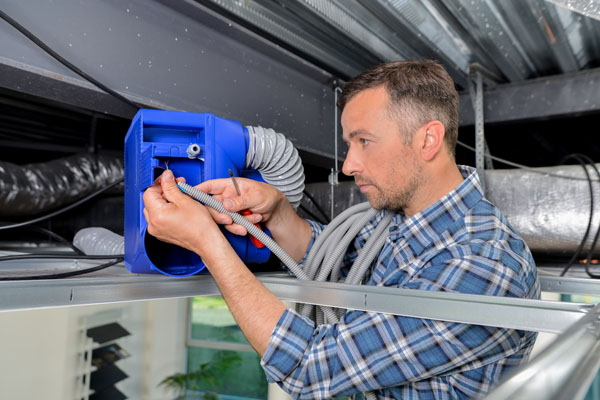 hvac technician working on hvac air ducts