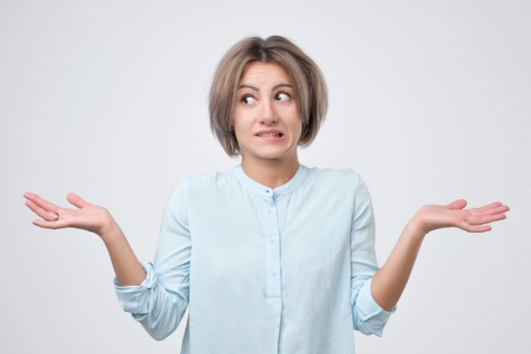 woman shrugging her shoulders depicting What To Do When You Discover a Furnace Leak