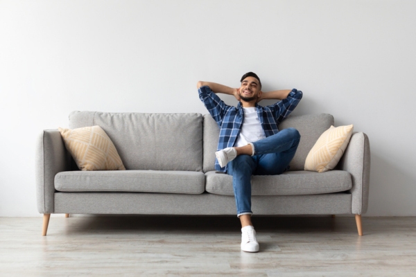 man keeping cool at home with a working air conditioner