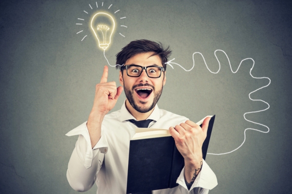 man reading a book with a lightbulb doodle beside his head depicting understanding Normal Moisture Vs a Heat Pump Leak