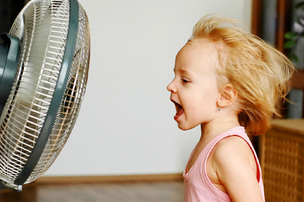 image of a child in front of fan to keep cool