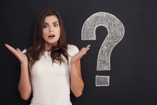 image of a wondering woman beside a big question mark doodle depicting What to Do If You Suspect a Refrigerant Leak