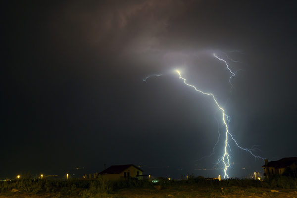 house with power at night during a power outage and backup generator