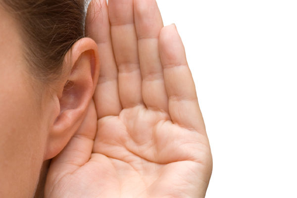 image of a homeowner listening to the oil tank alarm during heating oil delivery