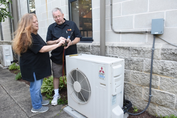 PFO Heating & Air Conditioning HVAC technician talking to a homeowner after an HVAC installation