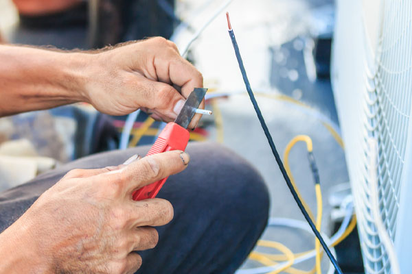 hvac technician preparing to install air conditioner