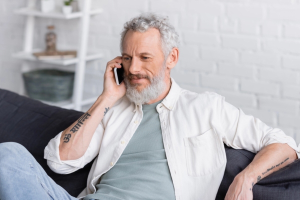 man talking on the smartphone depicting calling the experts for Advanced Generator Maintenance