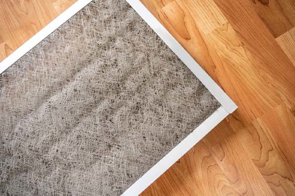 image of a dirty air conditioner filter that needs replacement