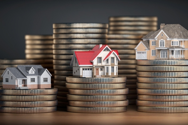 Houses of different size with different value on stacks of coins depicting home value