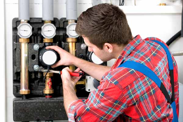 hvac technician servicing heating boiler