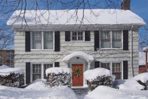 two story house covered in snow depicting home heating needs and fuel oil