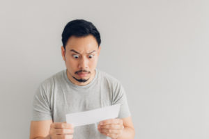 image of a homeowner looking at fuel bill in shock due to backup generator inefficiency