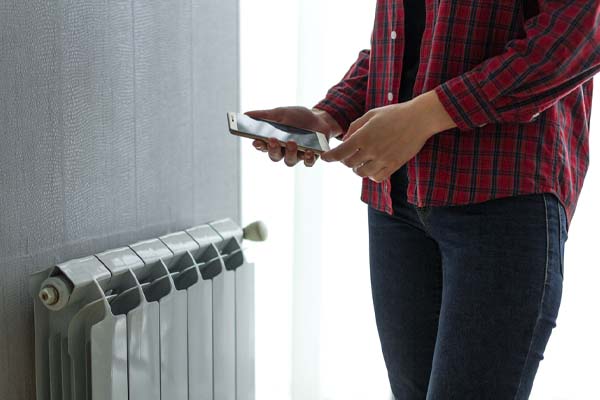 image of a homeowner controlling heating oil system remotely