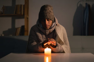 image of a homeowner feeling chilly due to hvac emergency