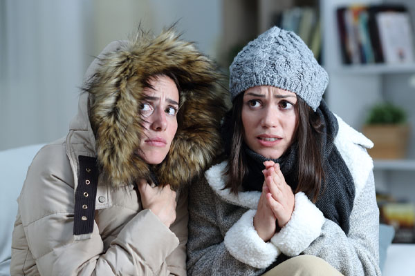 image of a homeowner feeling chilly due to leaky hvac ductwork