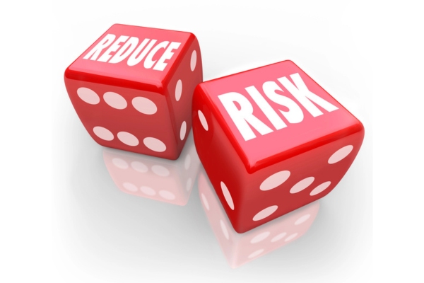 Reduce Risk words on two red dice depicting Costly Emergency HVAC Repairs