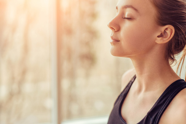 image of a homeowner breathing deeply due to healthy indoor air quality