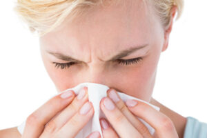 image of a homeowner experiencing allergies at home