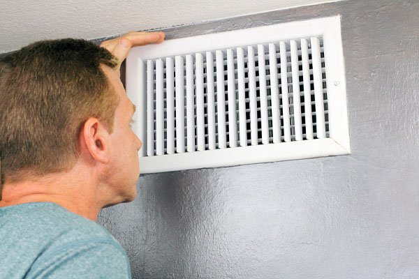 image of a homeowner wondering wall vent open or closed