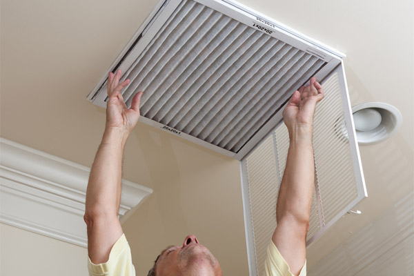image of an hvac air filter replacement  by hvac contractor