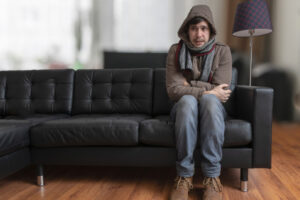 image of homeowner feeling chilly due to poor furnace sizing