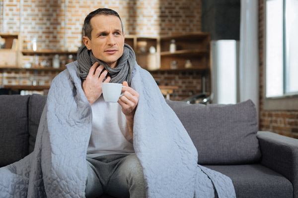 image of a homeowner feeling chilly due home heating problems