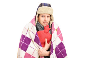 image of a homeowner feeling chilly due to poor heat pump heating in home