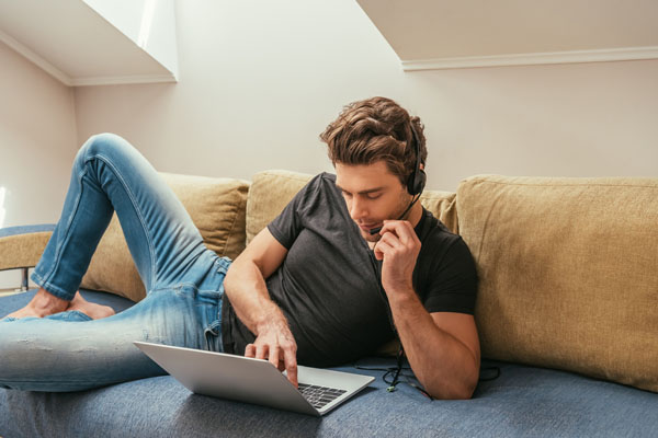 young adult working in attic room enjoying home comfort hvac system