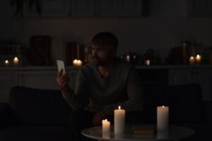 man on his phone during power interruption
