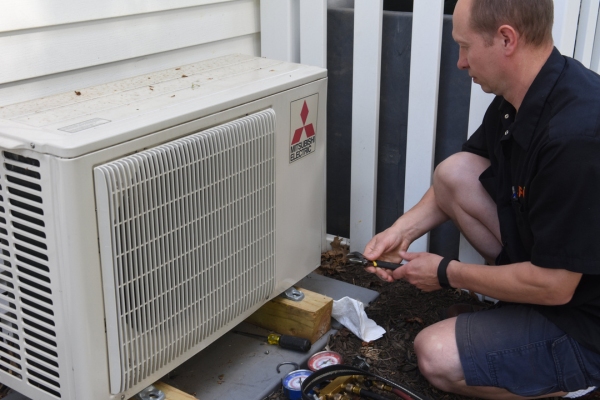 PFO Heating & Air Conditioning HVAC technician performing ductless AC maintenance