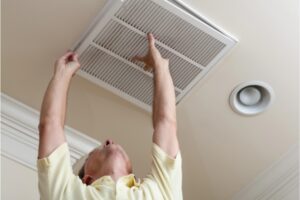 homeowner replacing HVAC air filter