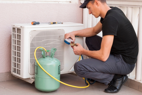 HVAC technician checking heat pump refrigerant level
