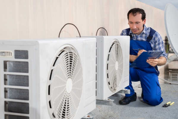 HVAC technician diagnosing heat pump issue during a heat pump repair