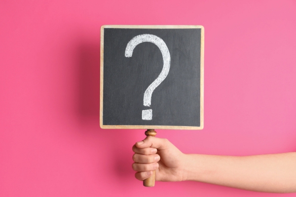 hand holding a sign with a question mark depicting FAQs about Oil Burner Cleaning