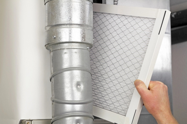 homeowner checking furnace filter