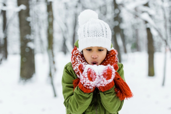 child blowing snow outdoors during winter depicting Market Demand and Seasonal Patterns