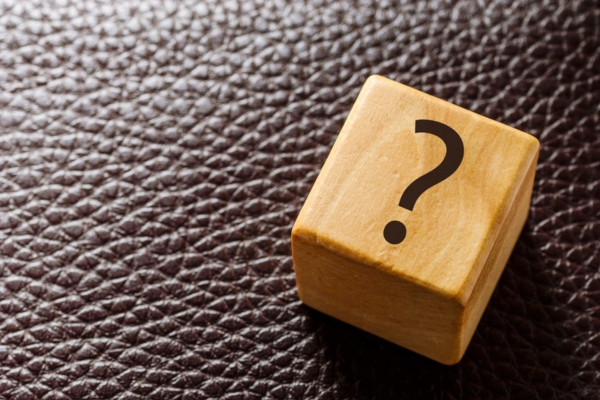 question mark on a wooden cube depicting Energy Efficient Heating System FAQs