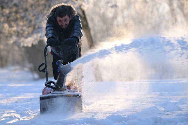 man clearing path for heating oil delivery using a snow blower