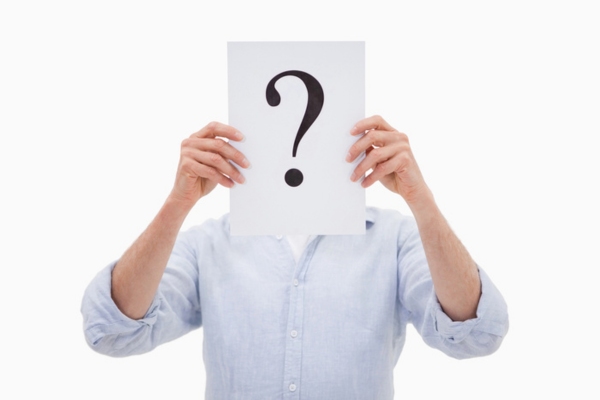 man holding question mark covering his face depicting AFUE vs AFUE2 FAQs