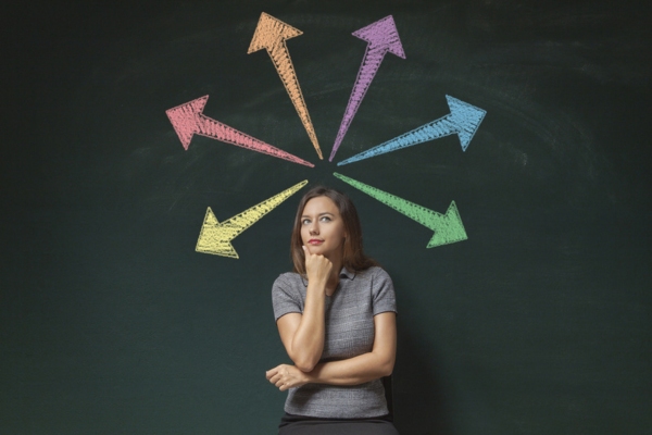 woman thinking with colored arrows behind her depicting making a decision