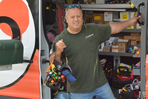 PFO Heating & Air Conditioning HVAC technician getting off the service van