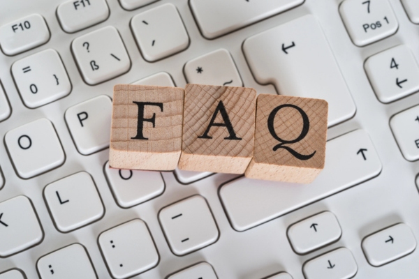 FAQ spelled using wooden letter cubes on top of a keyboard depicting Air Conditioning Scams questions